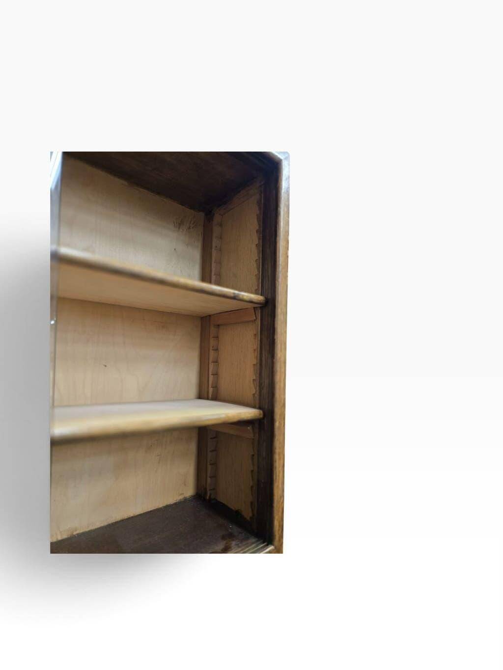 Vintage shallow wooden display shelf with sliding glass doors.