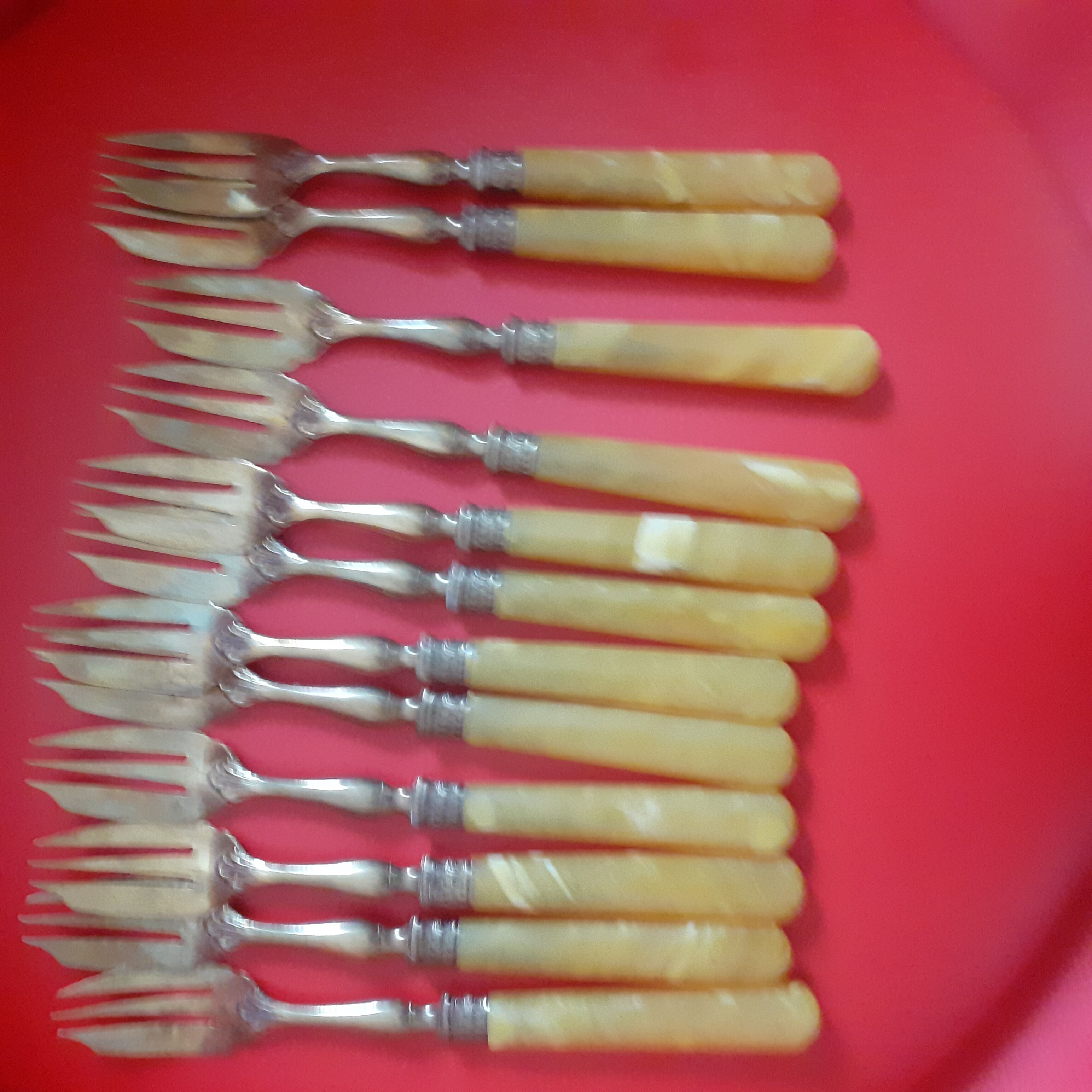 12 Cake forks. Around 1930. Golden metal and yellow Bakelite handle.