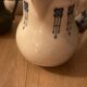 During antique milk jugs at a flea market.