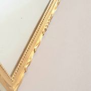 Golden mirror in the Louis XVI style from the 20th century.