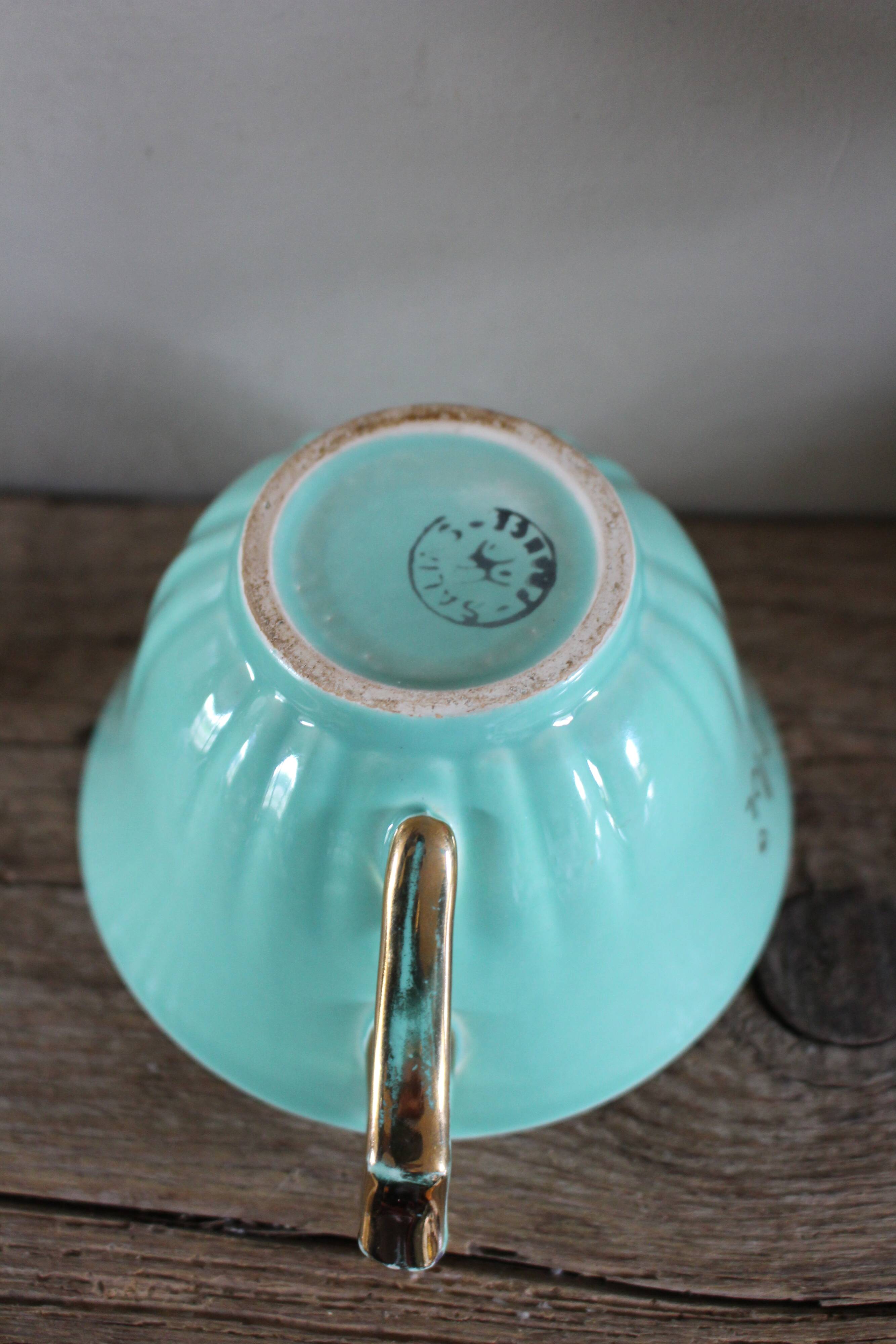 Green and gold cup from the Moi Salins collection.