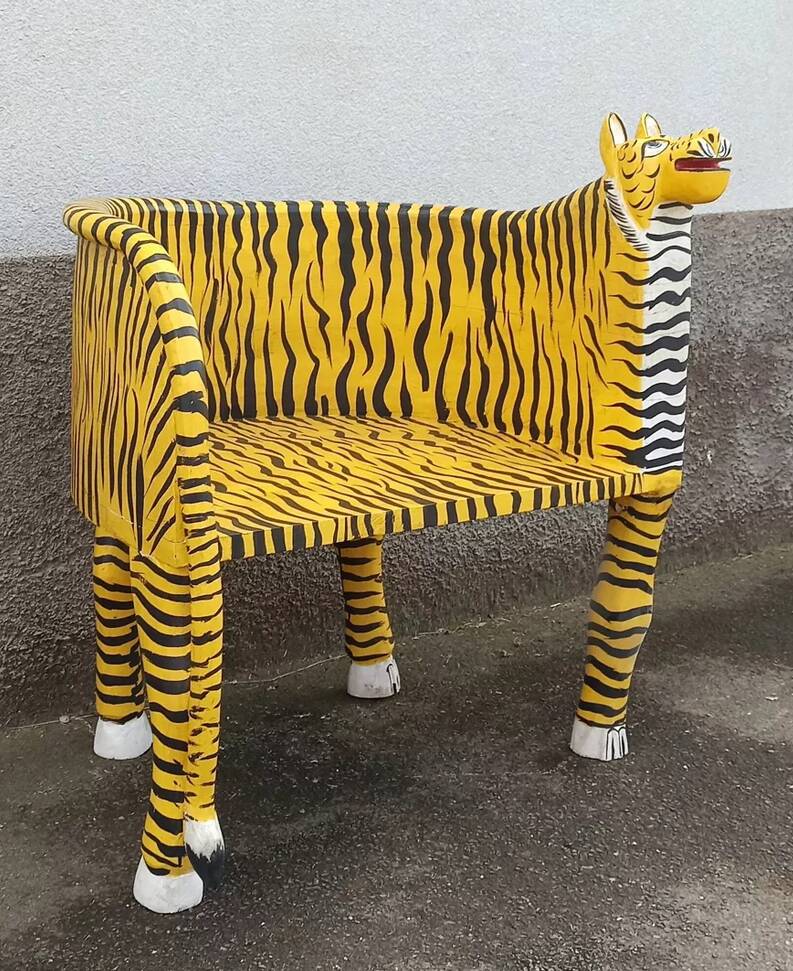 Wooden armchair with a "tiger" appearance.