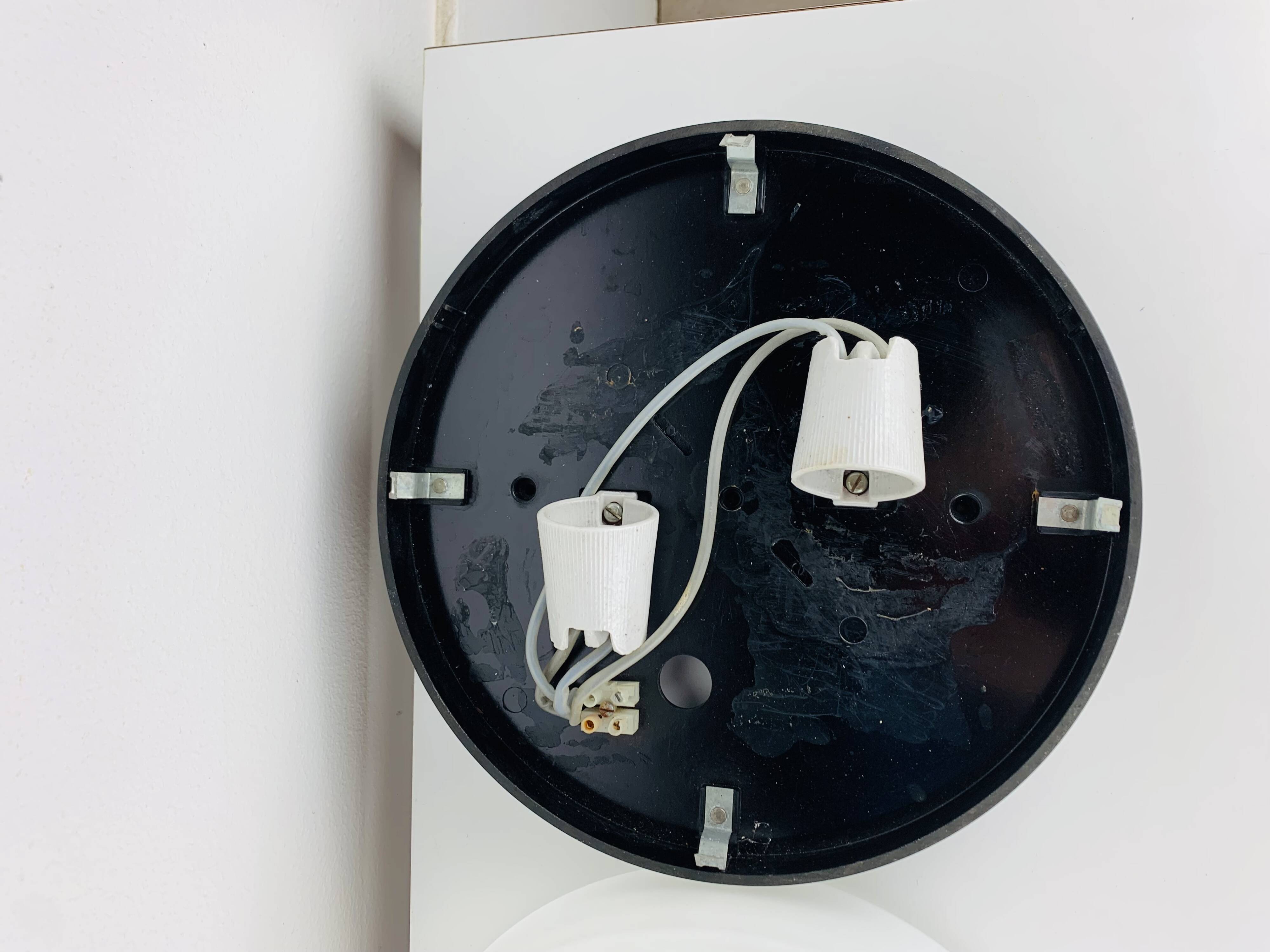 Erco round opaline wall light from the 1960s