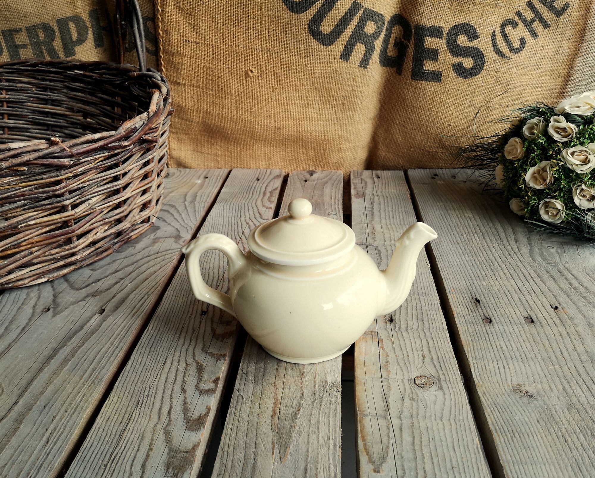 Little ancient teapot in ceramics color cream