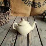 Little ancient teapot in ceramics color cream