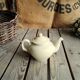 Little ancient teapot in ceramics color cream