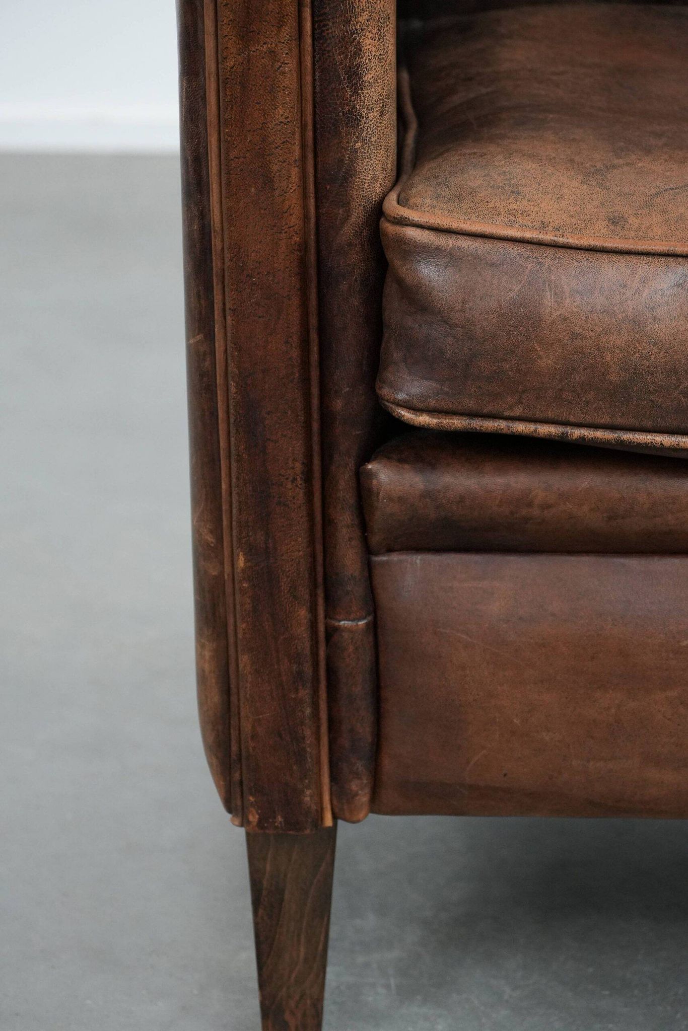 Vintage sheepskin armchair with warm colours and a characterful appearance