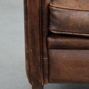 Vintage sheepskin armchair with warm colours and a characterful appearance