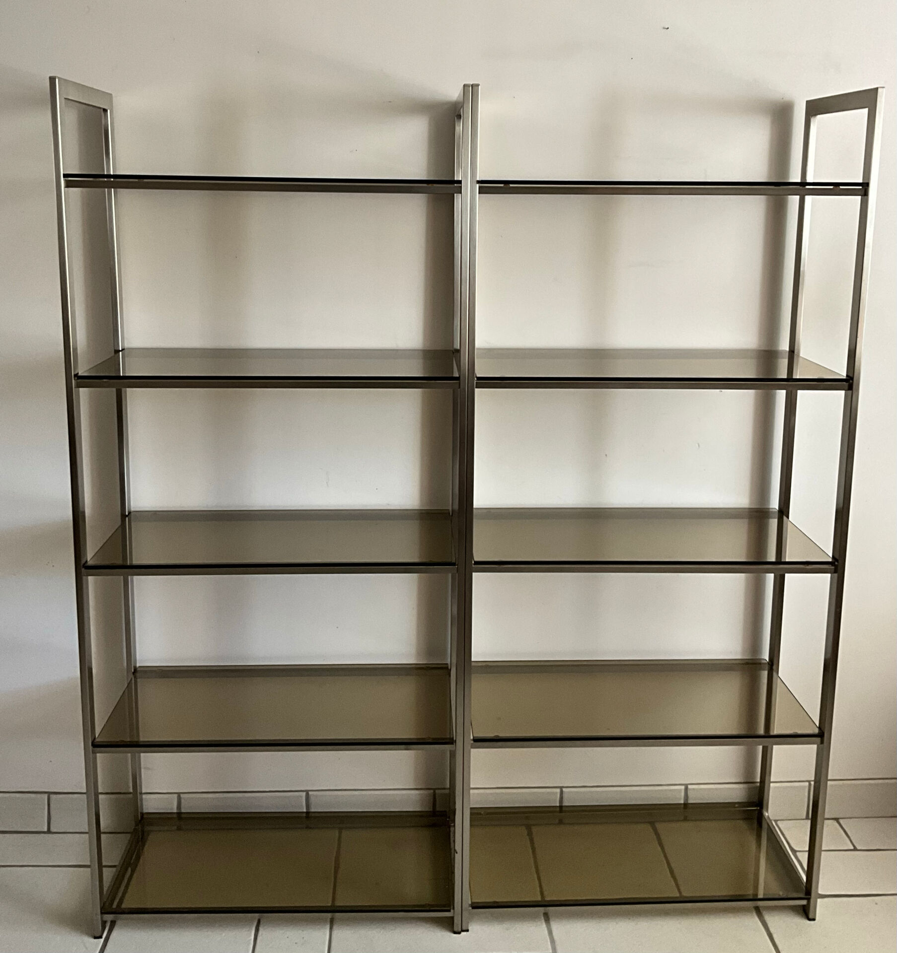 Pair of Artelano bookshelves in anodised metal and smoked glass, 1970s.