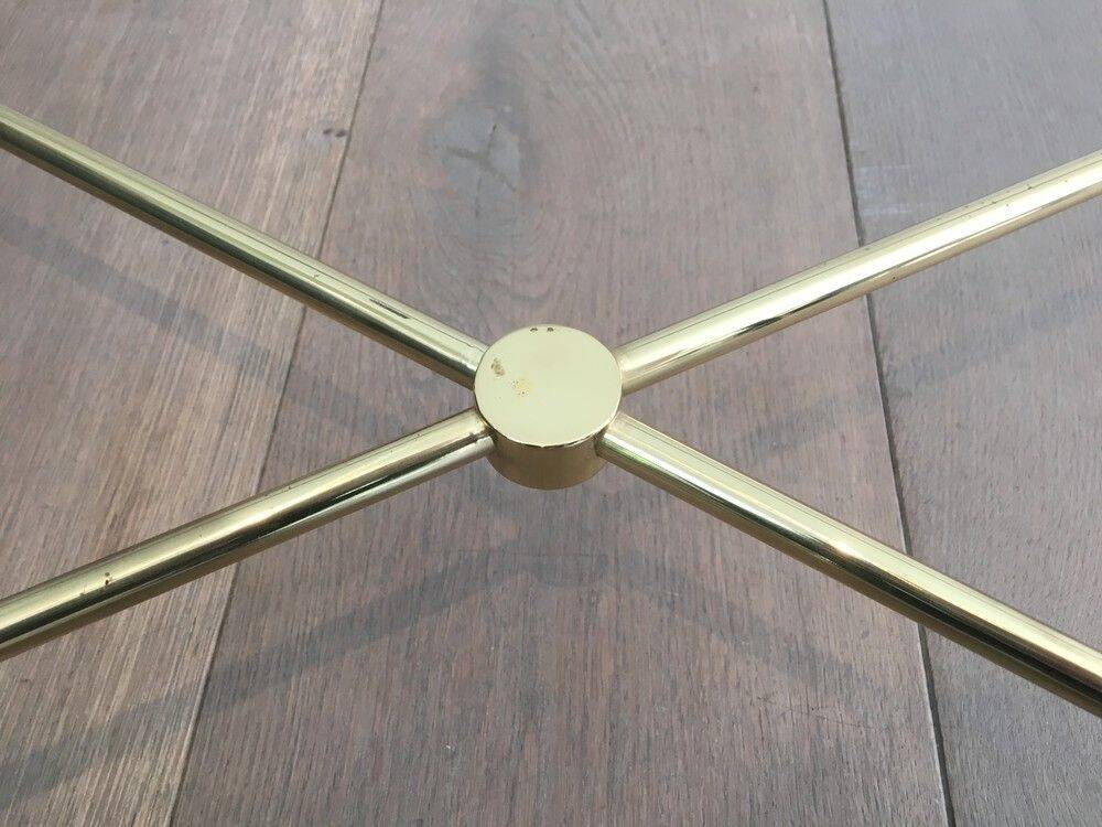 Brass coffee table upholstered in black leather. In the style of Jacques Adnet.