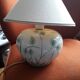 Antique ceramic lamp with a floral design.