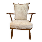 Scandinavian armchair in solid wood with beige fur cushion