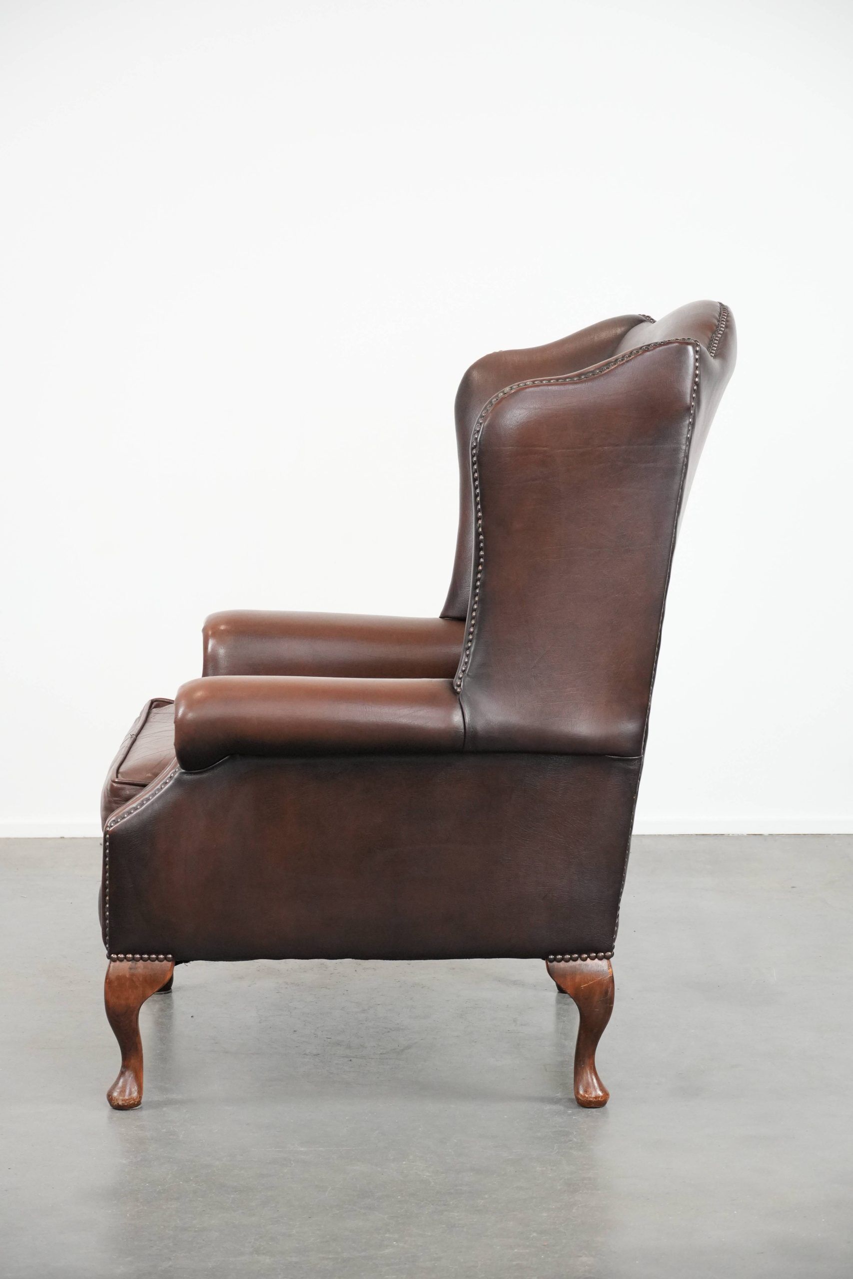 Brown smooth cow leather Chesterfield wingback armchair in English style