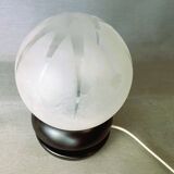 Small black wooden table lamp with frosted glass globe