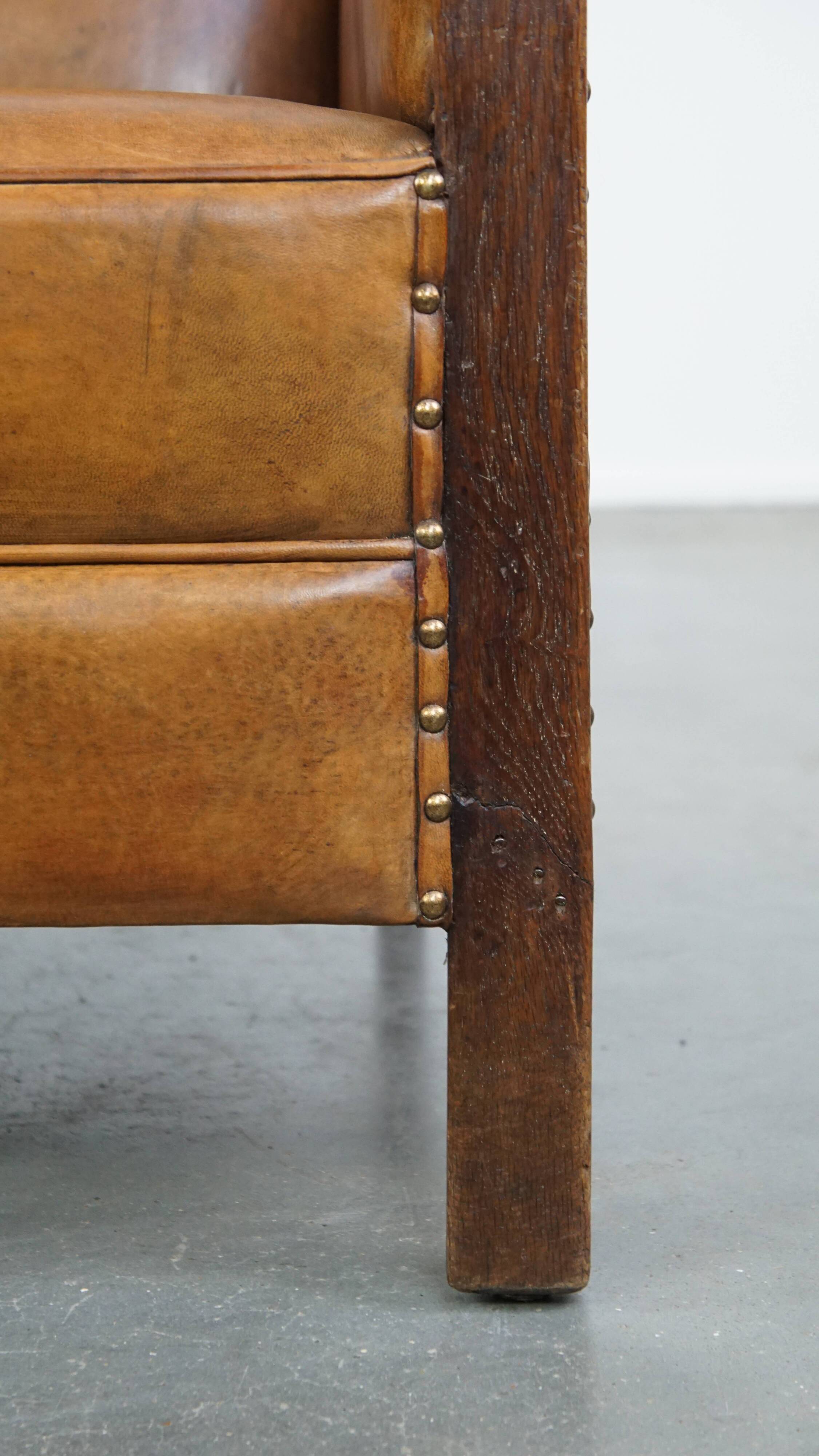 Cognac-colored sheepskin and wooden Art Deco design armchair