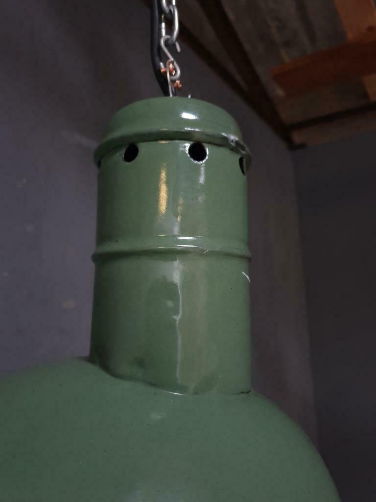 Old industrial enamel lamp in green