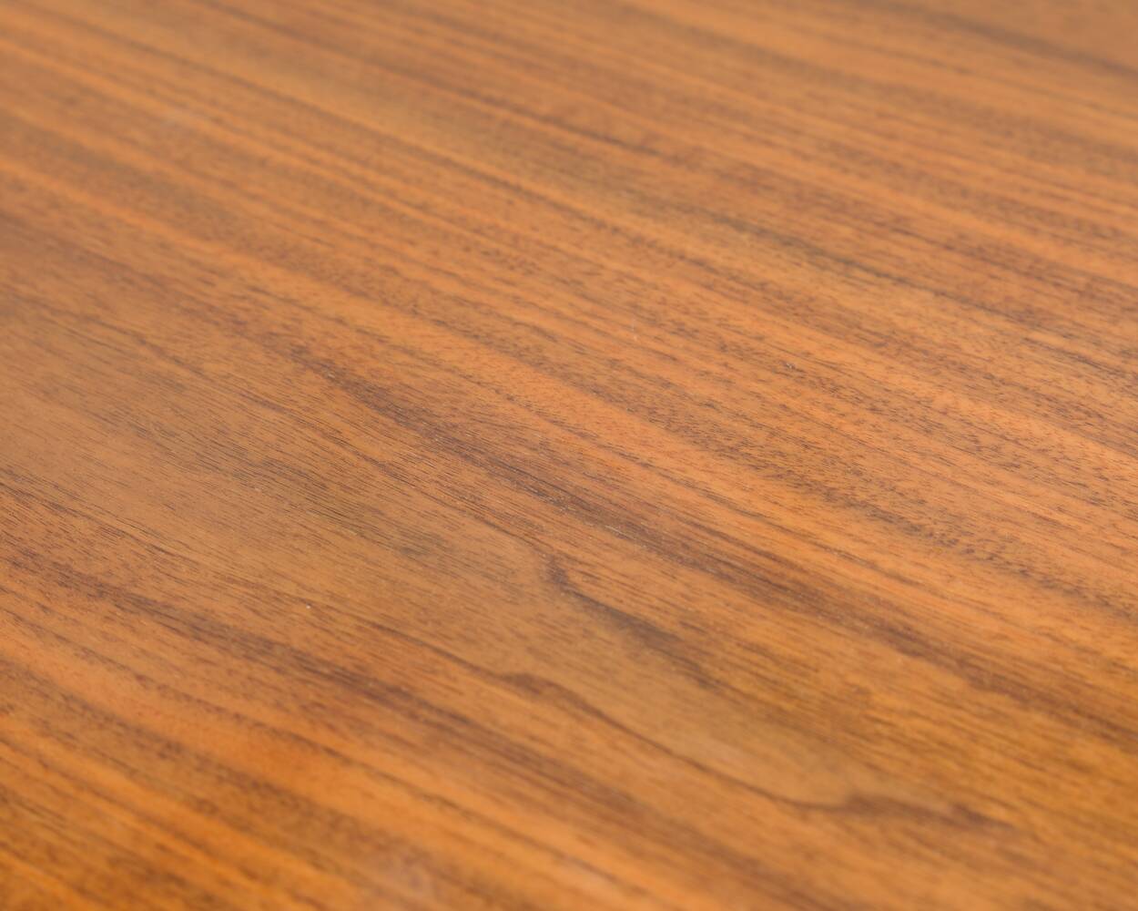 Dining table, 1960s, in walnut, slightly elliptical shape.