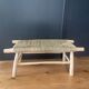 Natural wood bench and braided doum.