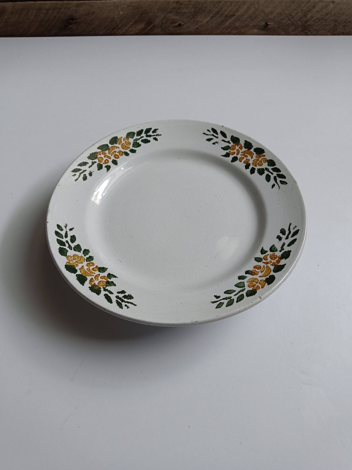 Old round footed plate signed Labrut brothers flowers