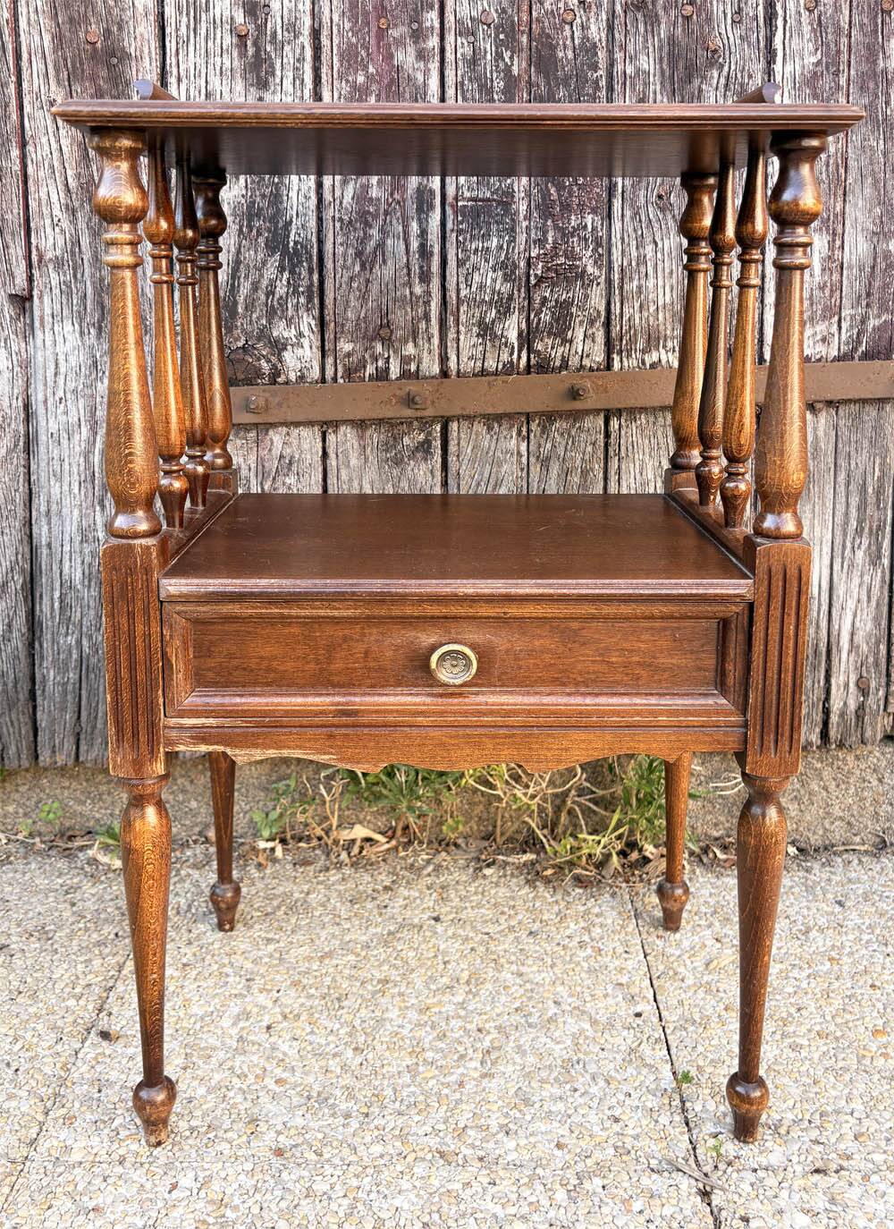 Solid wood bedside table with turned columns, early 20th century.