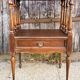 Solid wood bedside table with turned columns, early 20th century.