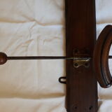 old wall coat holder made up of 3 wooden and metal pads.