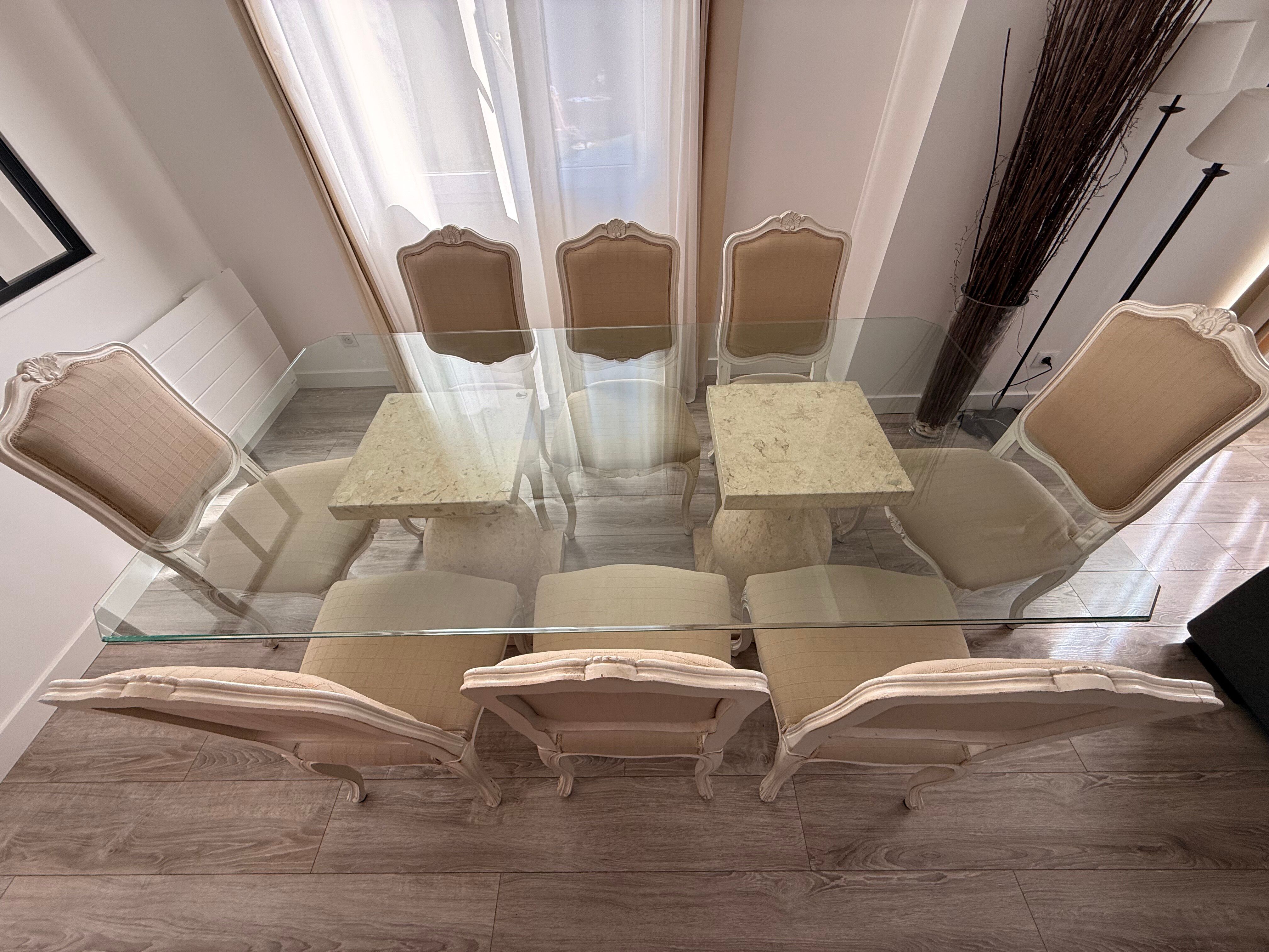Table with a glass top and 8 chairs.