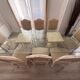 Table with a glass top and 8 chairs.