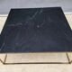 Table basse en marbre noir et laiton