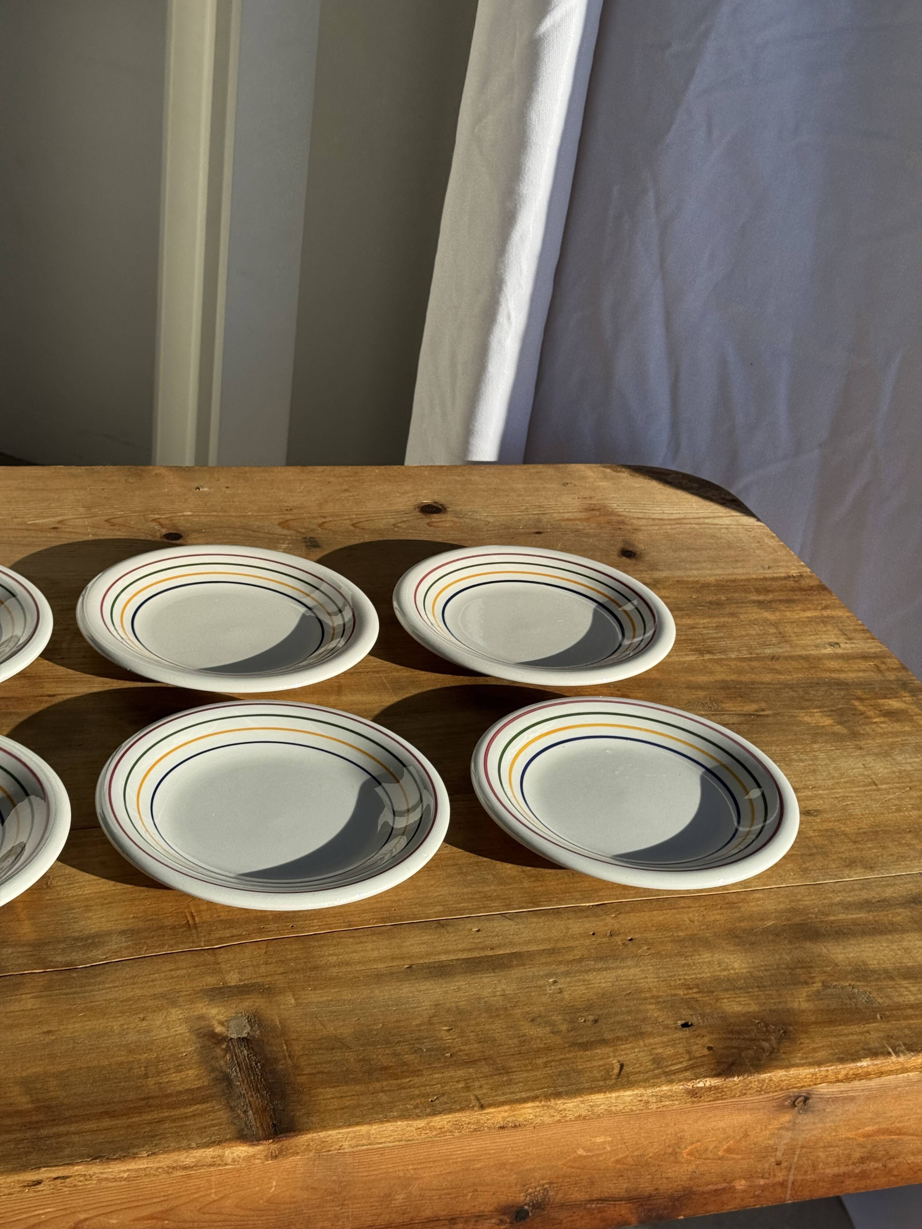 Set of 9 small Italian dessert plates Primula with red and green trim.