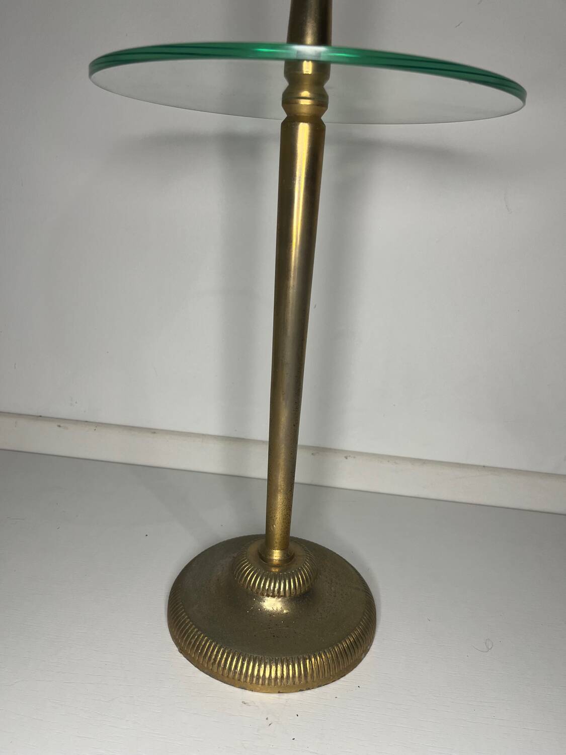 Vintage brass floor ashtray with glass shelf in Empire style.