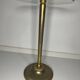 Vintage brass floor ashtray with glass shelf in Empire style.
