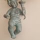 Pairs of wall lights, either two distinct cherubs.