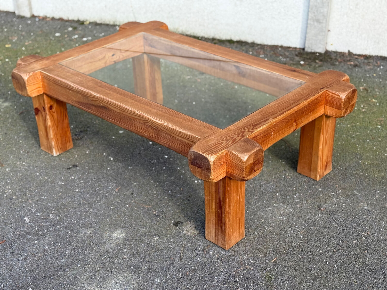 Coffee table with a glass top in Scandinavian brutalist style made of pine.