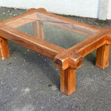 Coffee table with a glass top in Scandinavian brutalist style made of pine.