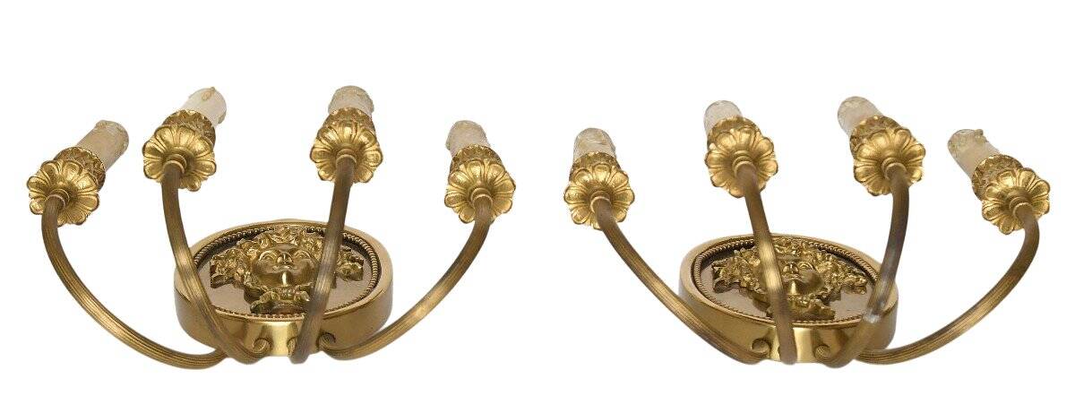 Pair of wall sconces with a relief decoration of a Bacchus mask.
