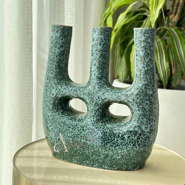 Artisanal vase in black and blue.