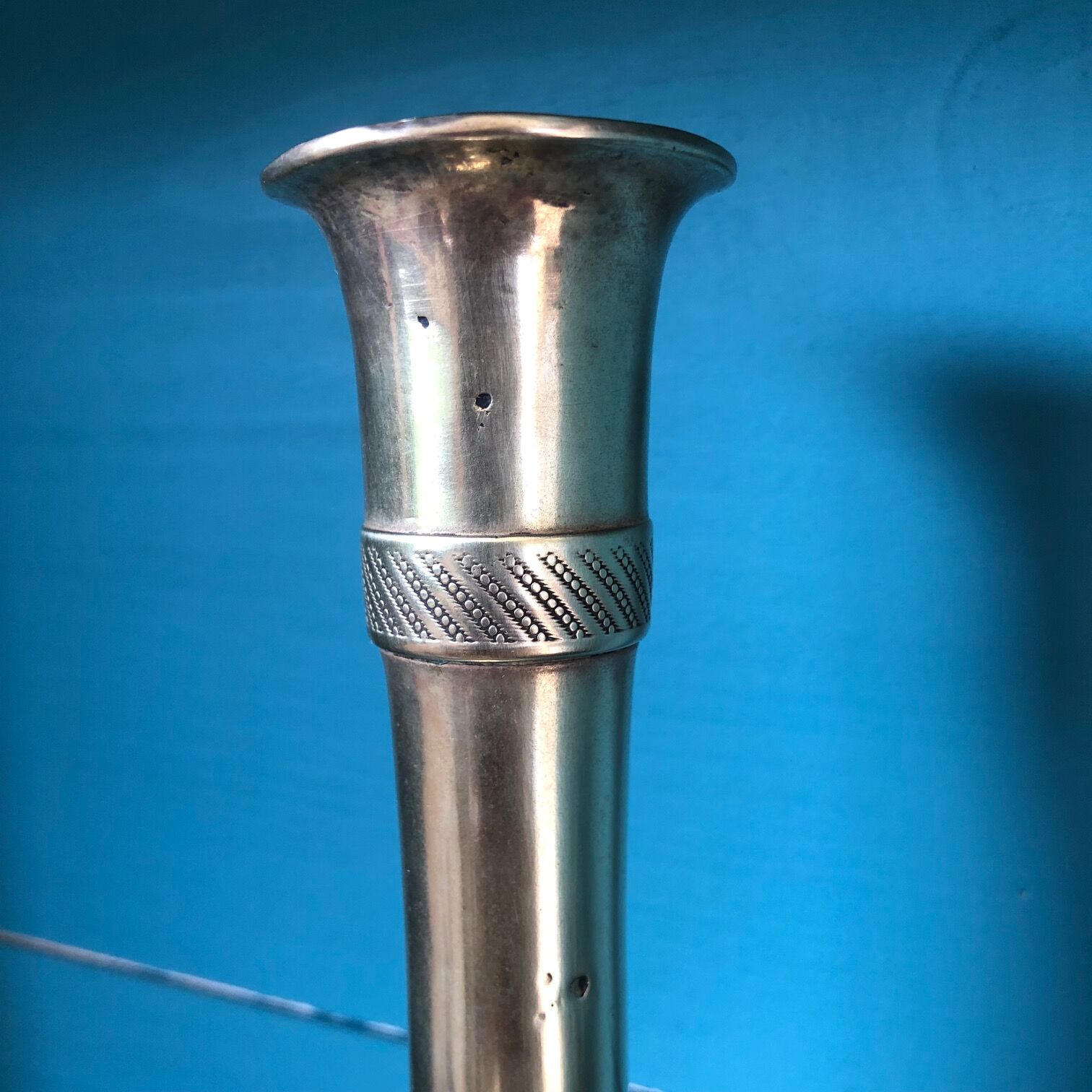 Large candlestick in chiseled brass