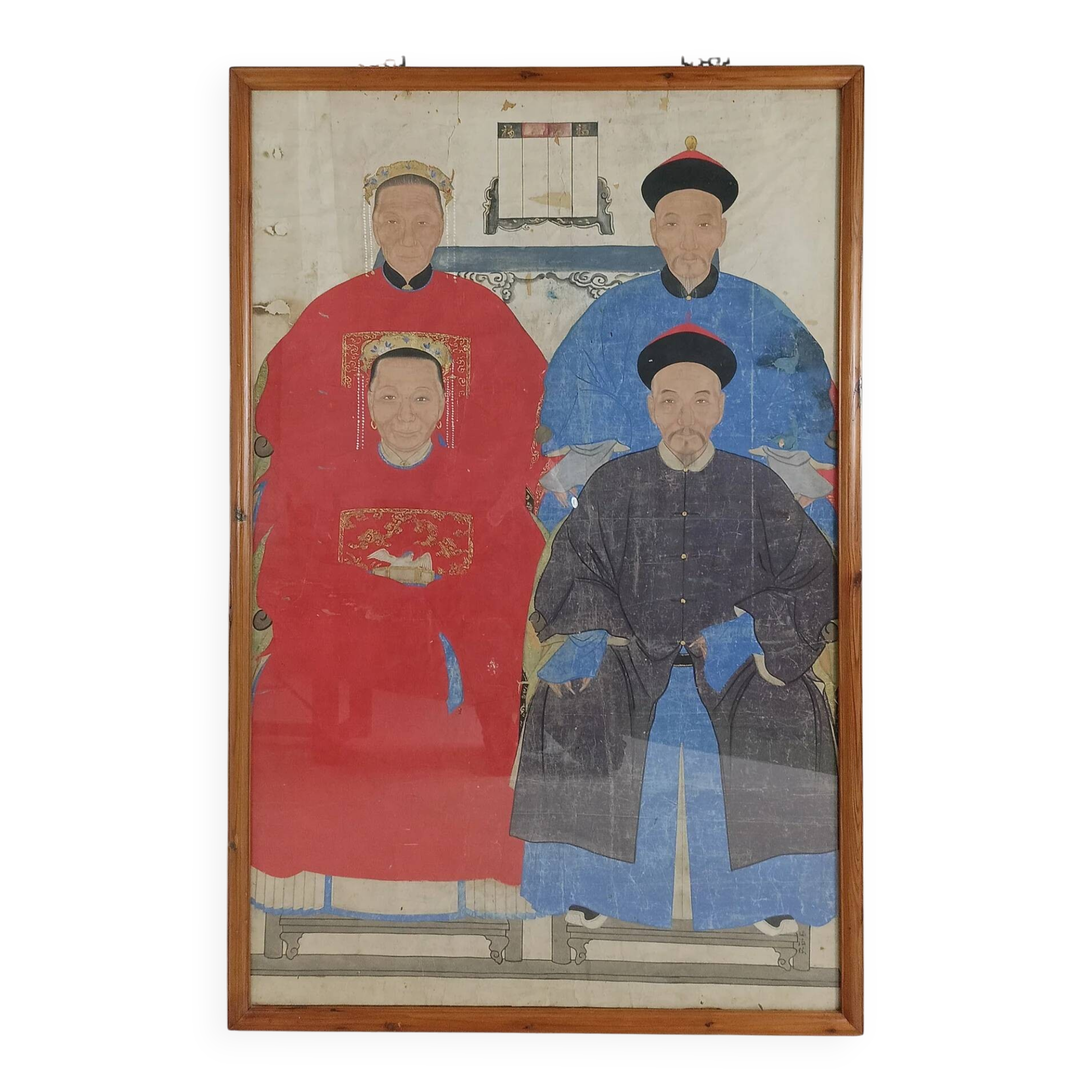 A framed Chinese ancestral portrait is a traditional hand-painted