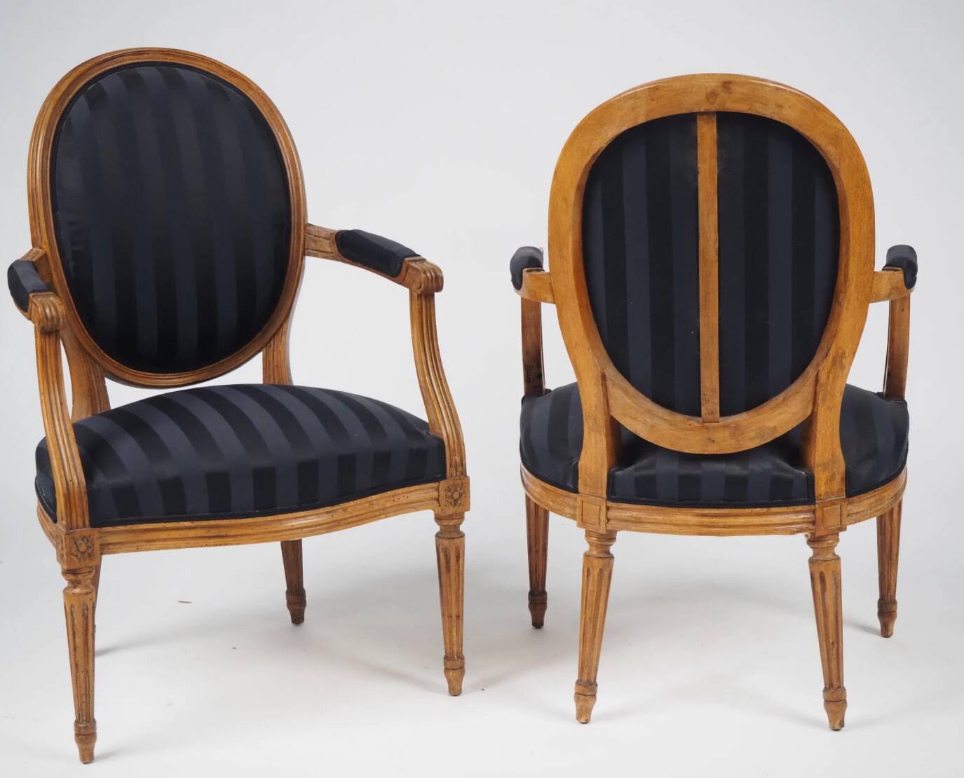 Pair of Louis XVI style cabriolet armchairs in natural wood.