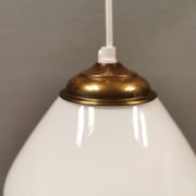 Beautiful ball-shaped hanging lamp in white opal glass with brass top.