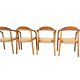 Set of 4 solid wood chairs with cord and armrests.