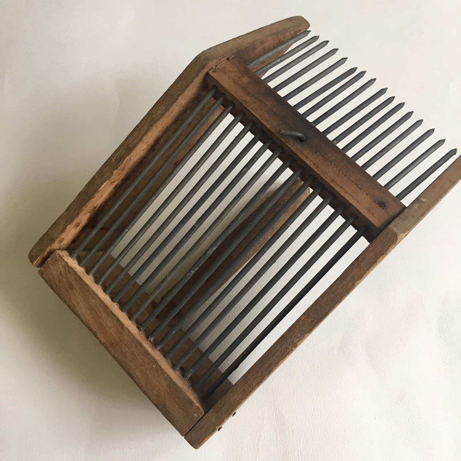 Old comb with berries (blueberries ..) in wood and metal