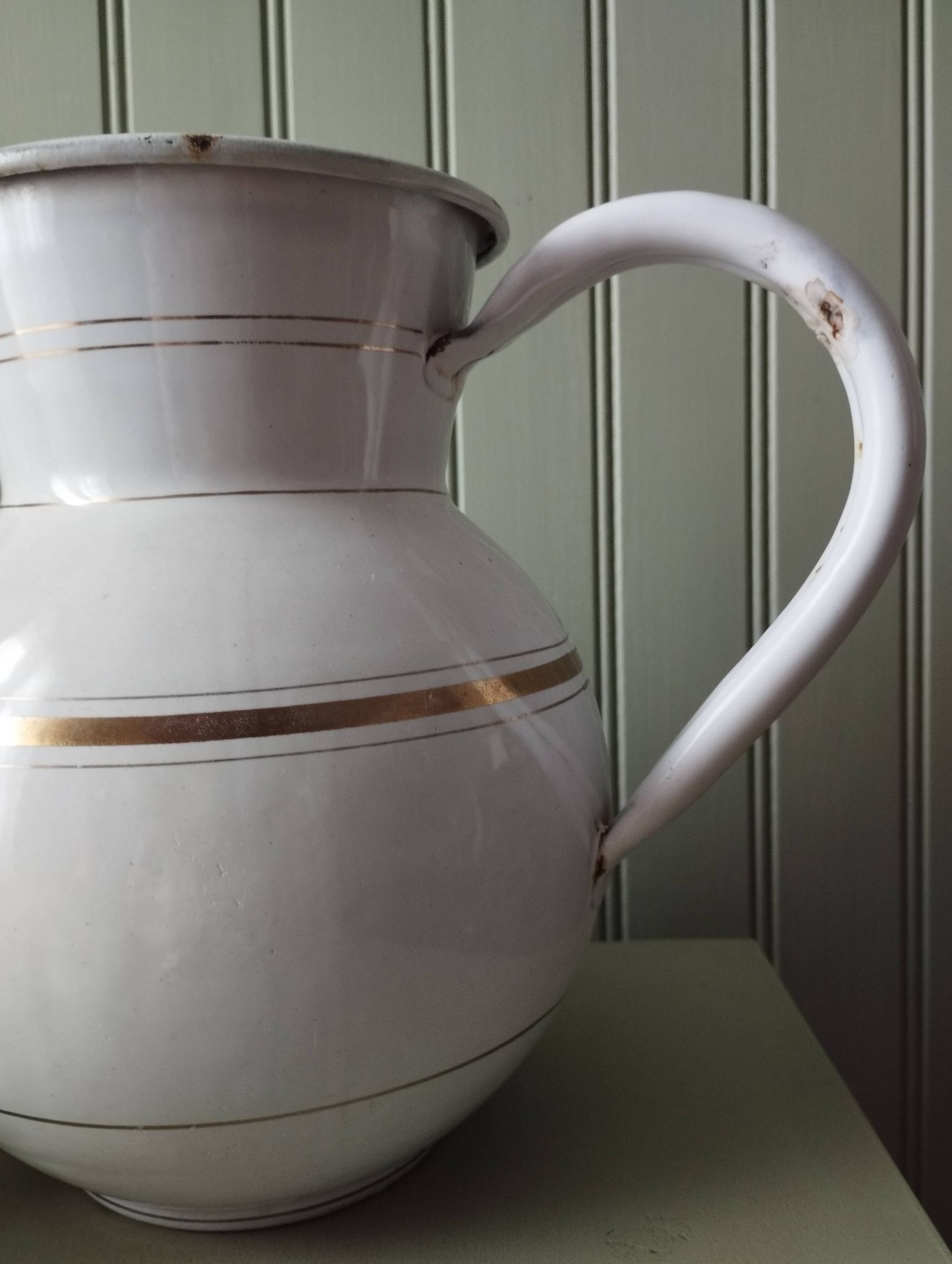 Rare large, pot-bellied toilet jug in white enamelled sheet metal with gold edging