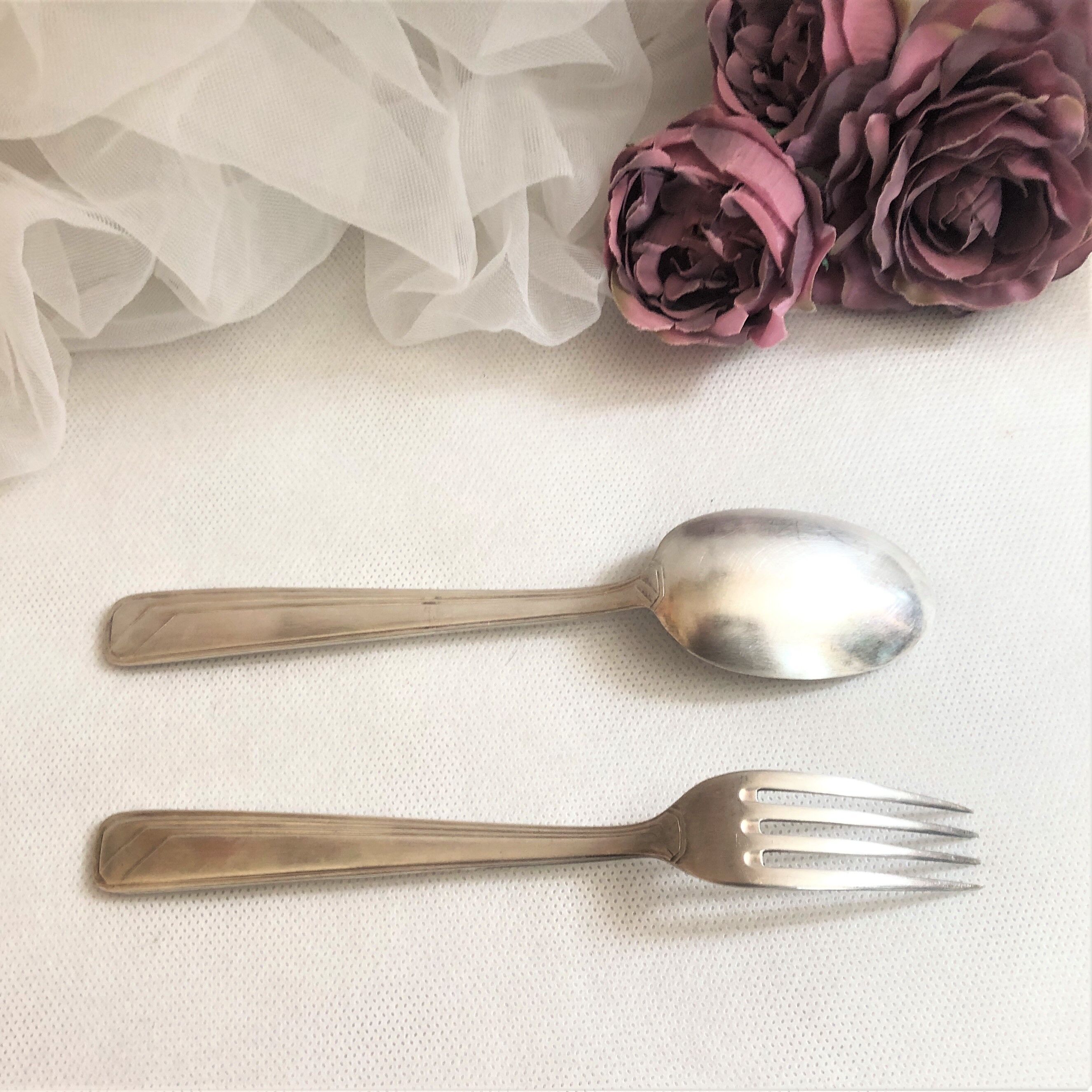 Set of 2 silver metal cutlery with punches
