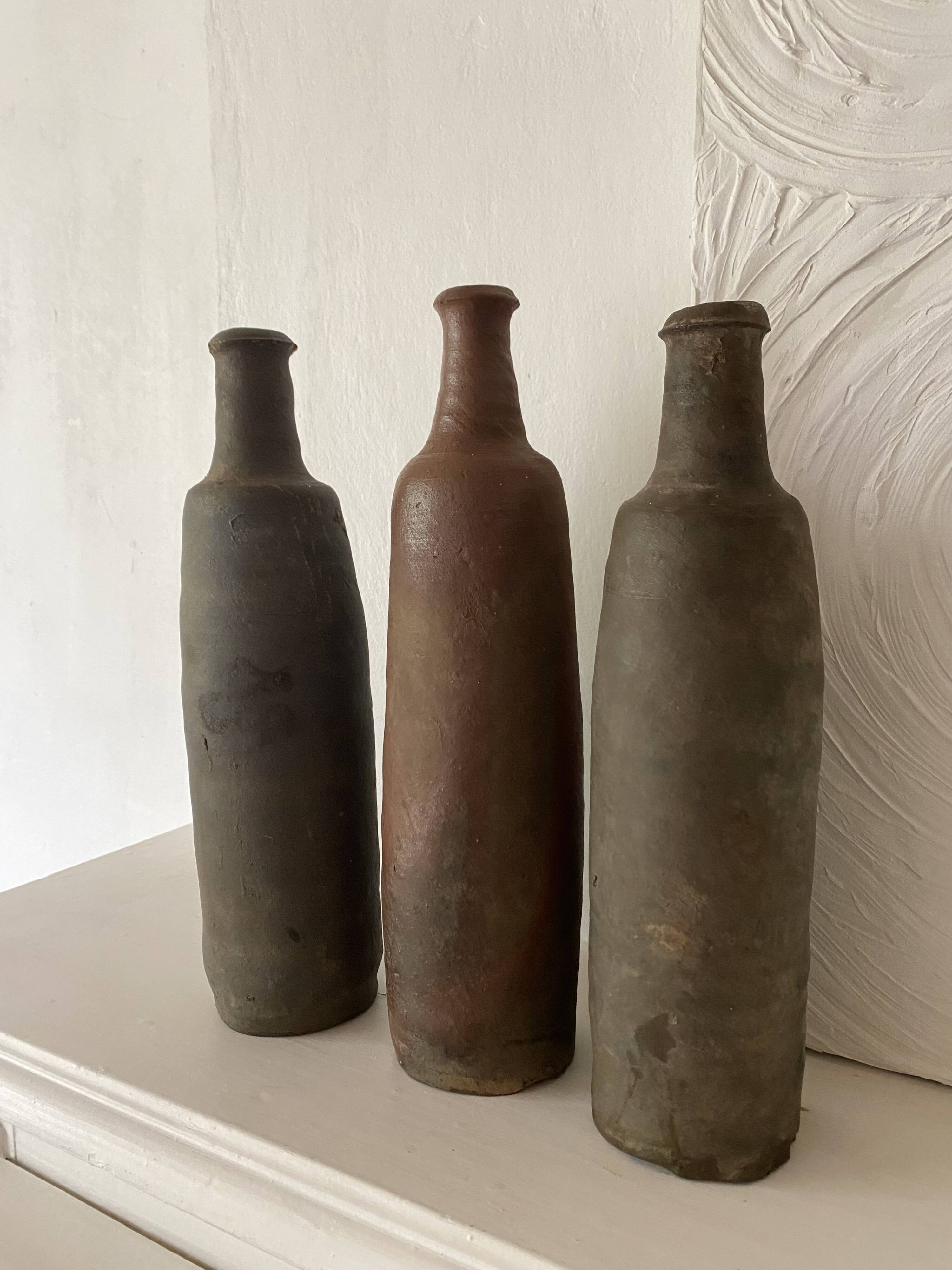 Antique terracotta cider bottles