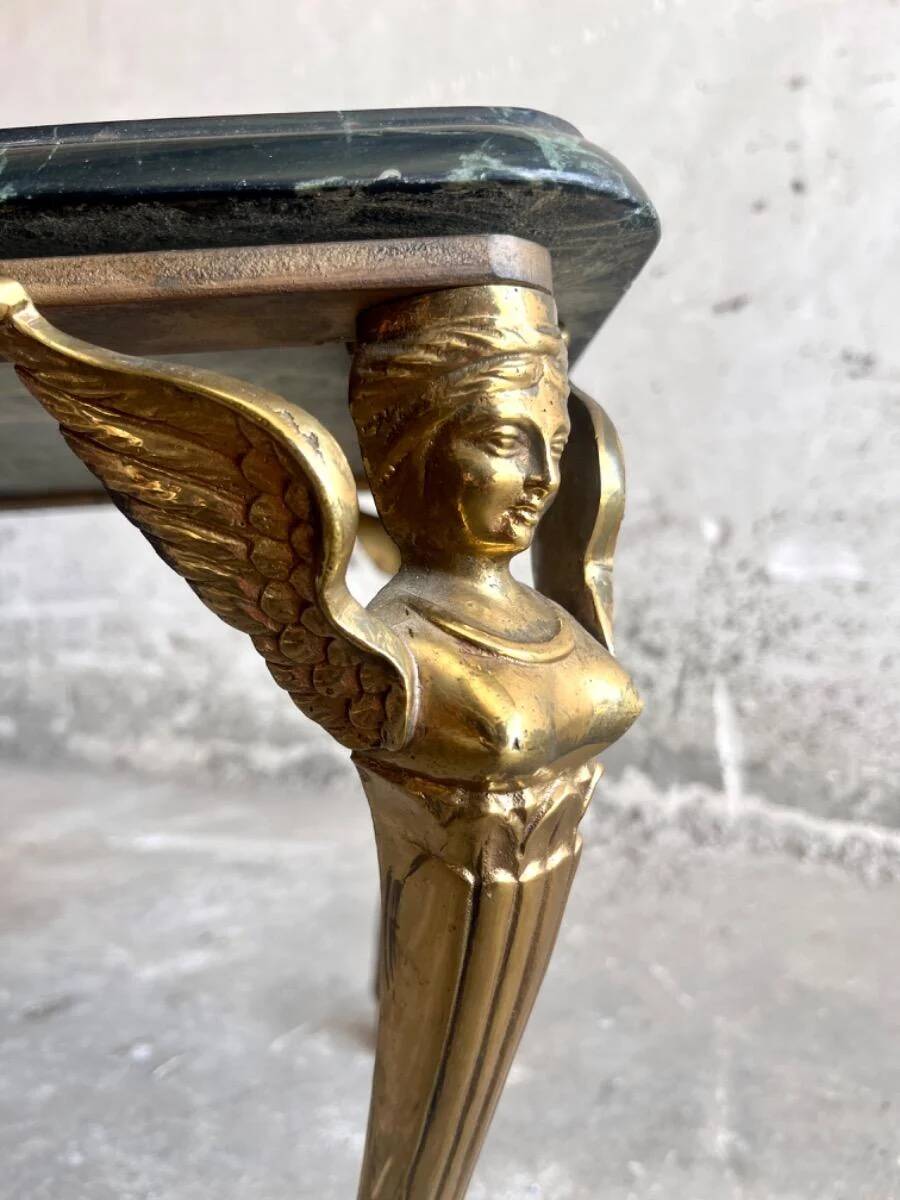 Vintage coffee table with a green marble top and gold legs.