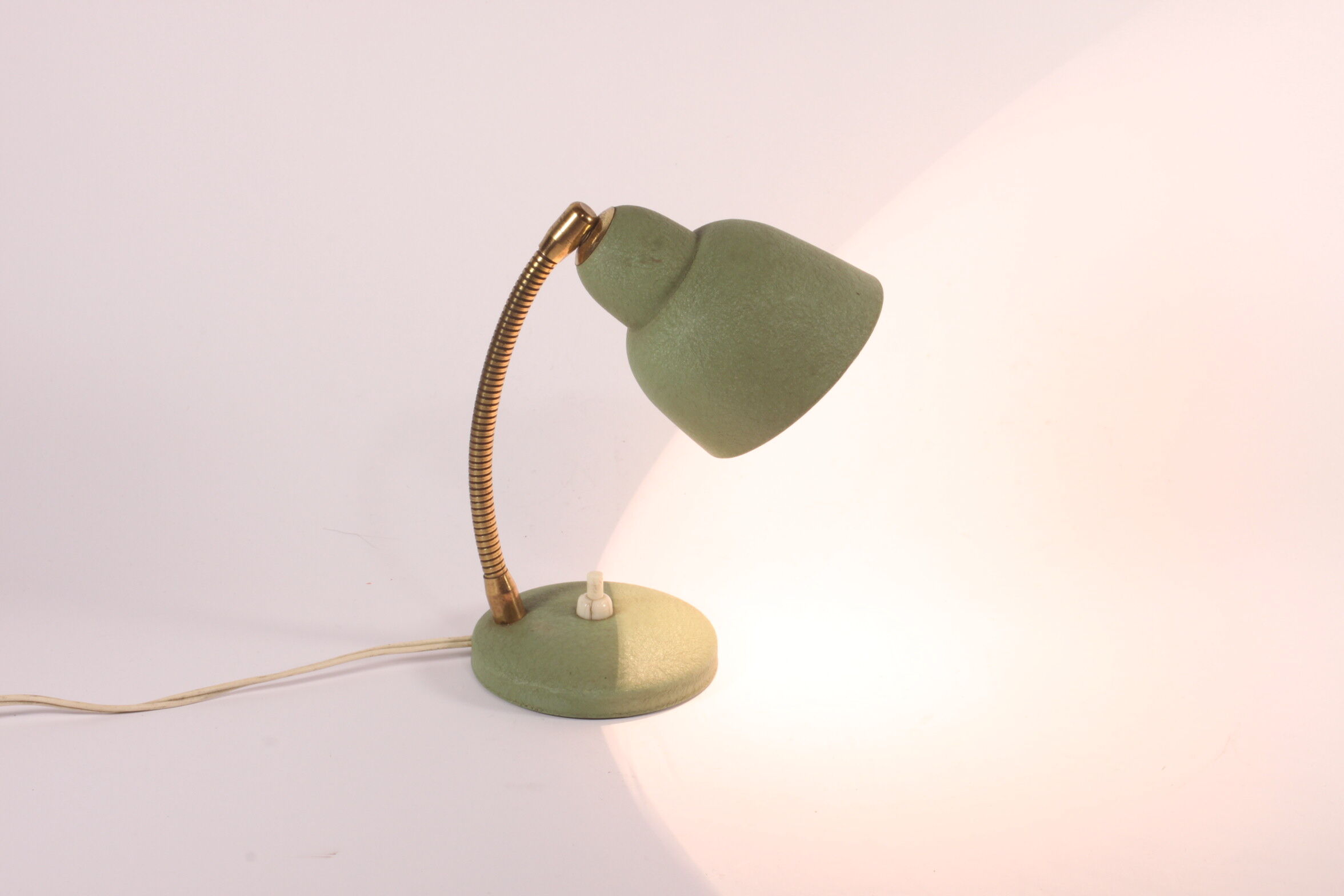 Flexible brass and green metal bedside lamp, 1950s.