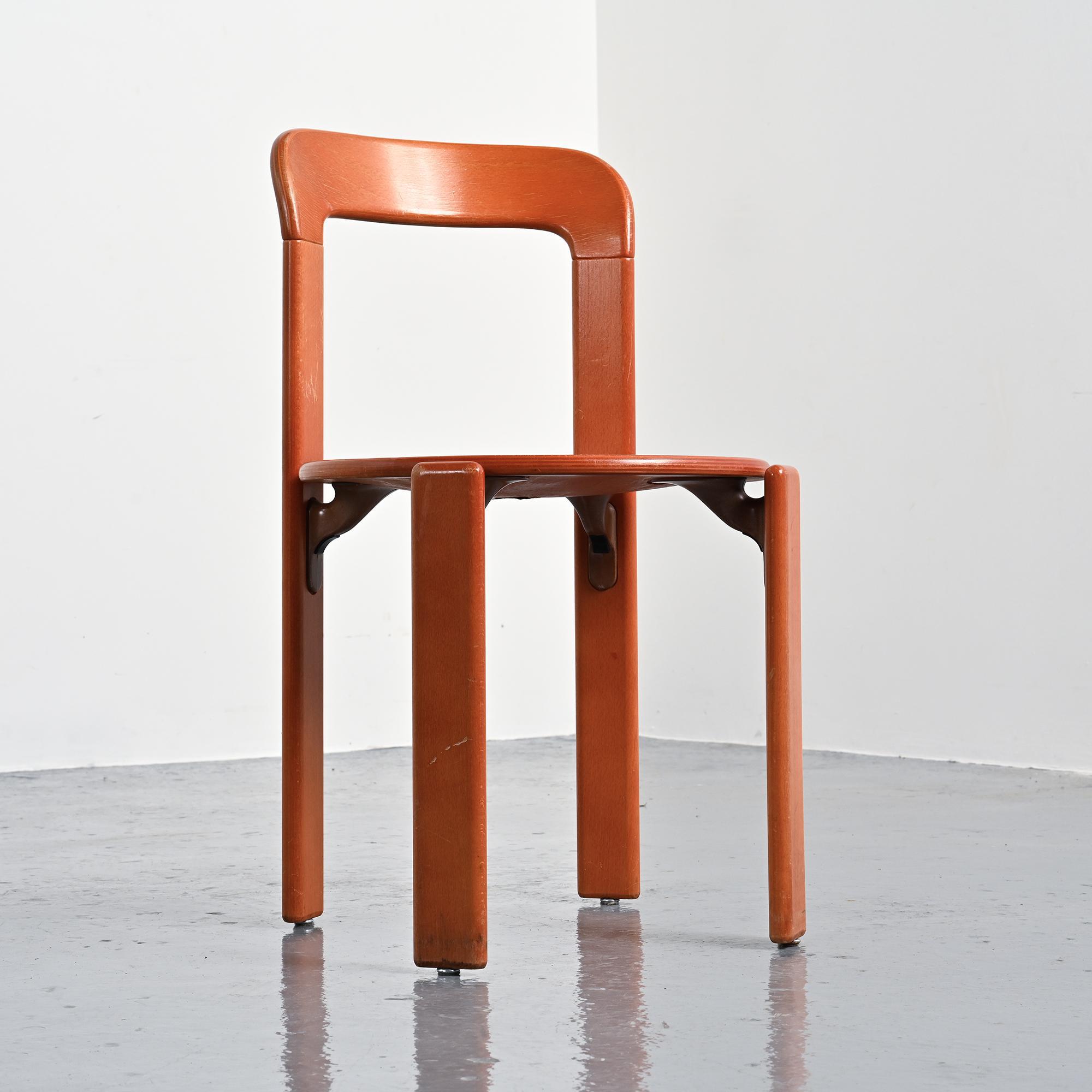 Rey chairs in stained red beech by Bruno Rey