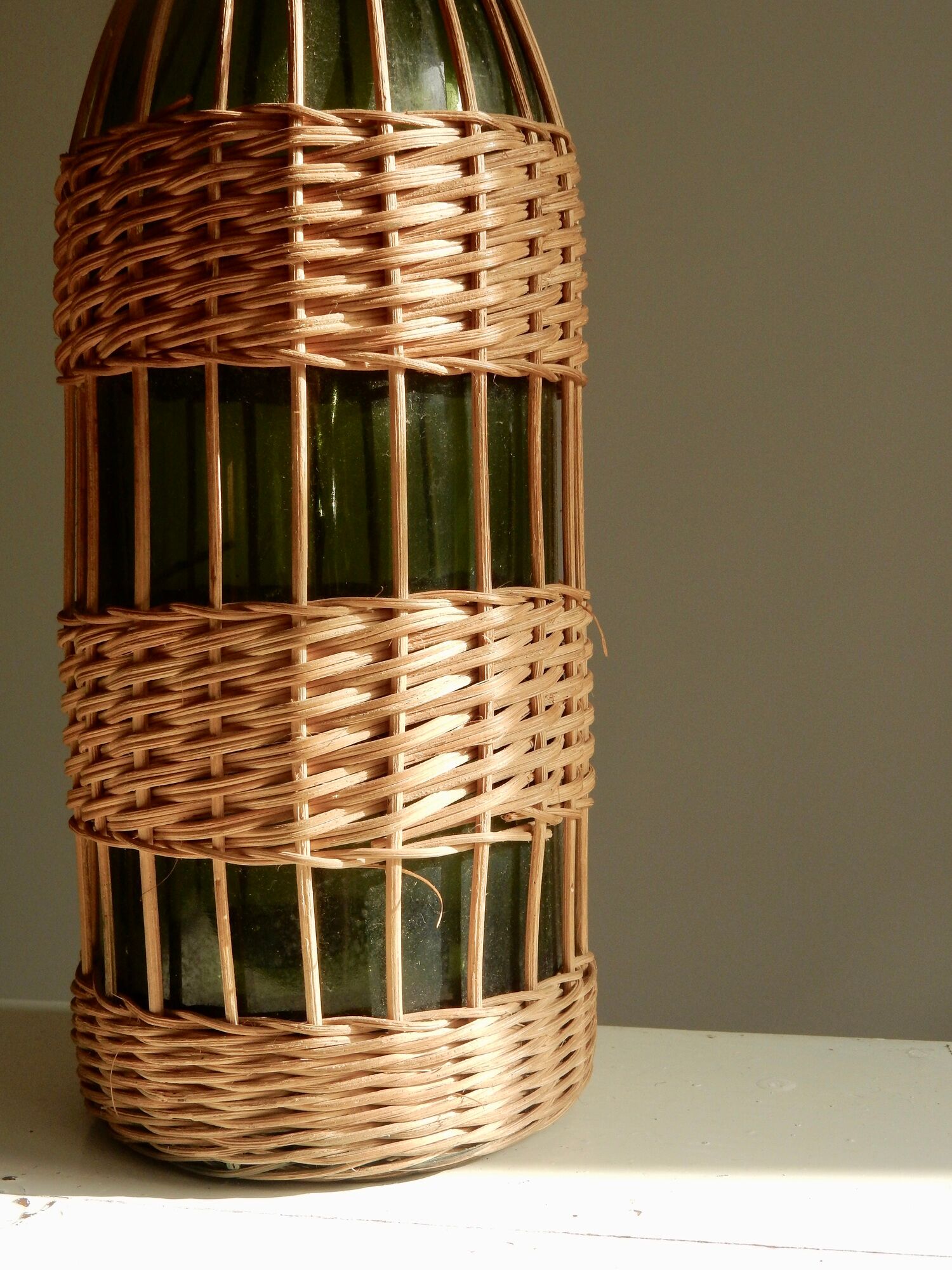 Glass bottle covered with wicker, France of the 60